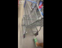Guy sticks cellphone inside shopping cart gap at walmart