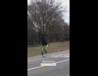 man bright green pants unicycle park