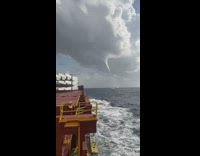 Waterspout being formed on the ocean clouds