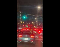 Legs of passenger in convertible car dances