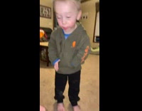 Little boy has white hamster in hoodie jacket 