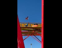 Theme park employee pushing stuck rollercoaster ride