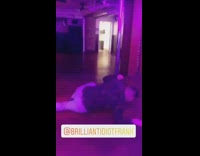 Guy swings on stripper pole purple lights