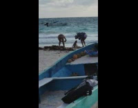 Girl lay on beach knee up boat