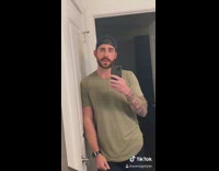 Green shirt guy takes panoramic selfie photo 