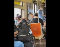 Man has grey face cover as mask