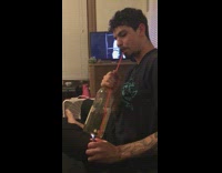 Guy puts fire under wine and then breathes out smoke 