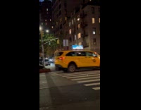 Car drives on sidewalk avoiding road block