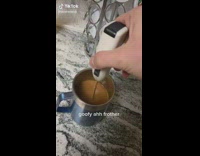 Broken coffee frother spins wide in blue cup