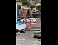 Woman pink bikini on blanket at beach