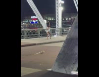 Woman white onesie dance twerk on bridge