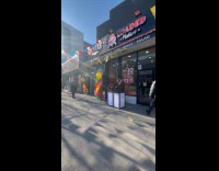 Man shirtless dances outside restaurant grand open