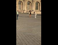 Woman in black dress models on the park