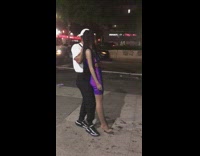 Man in white carries mannequin by the head 