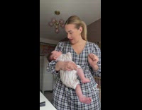 Woman holds baby and baby farts