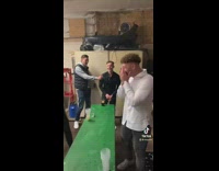 Guy shoots and wins at beer pong 