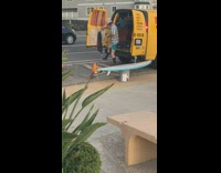 Guy standing at back of van kicking fabric on doors
