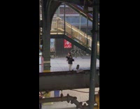 Guy playing a bagpipe under the bridge 
