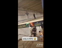 Girl stands support beams over stairs subway 