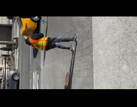 Guy wearing black boxing gloves punches air