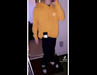 Guy in yellow hoodie phone in pocket peeking out 