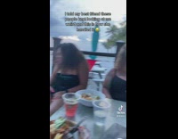 Girl at table pretends to act crazy to scare off people