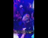 Send help for real this time Heather is reading a book at the bar