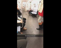 Man with cane sleeps and hunches over on subway train