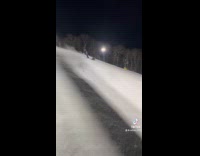 Man filming friend snowboarding 