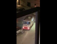 Ice cream truck on corner of street at night 