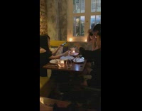 Girl holds pasta up for photograph 