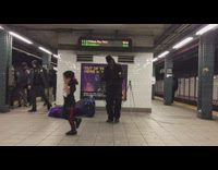 Little boy dancing to subway performer 