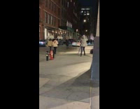 Guy follows girl posing model sidewalk