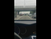 Person stands middle of freeway highway cars 