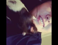 black rat on owners face touching her mouth 