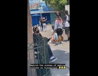 Three people tiktok dance in front of garbage bin