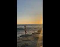 Collab IITW - Woman poses and reached by beach wave