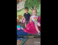 Kids at nursery give funny look at adult guy sitting with them