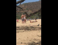 Man lifts tree leaves for the photoshoot effect on the beach