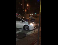 Man Rides White Car Down Street