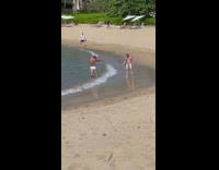 Man in underwear flexes muscle at the beach