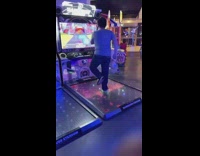 Guy reacts to guy playing dance arcade game 
