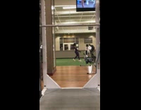Girl pulls cart two tires indoor gym
