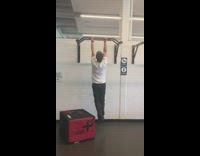 Man in white top pull-ups with a weird pose