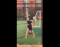 Man practices with soccer ball upside down