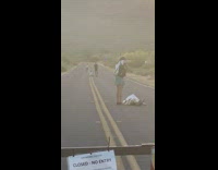 People cross blocked off street for photos 