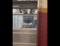 Guy hanging upside down on subway shadow boxing