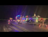 Houses with Christmas lights decoration and the word Ditto in the yard