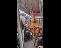 Chicken mascot sells egg while riding subway