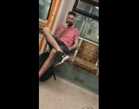 Guy brushes his teeth on subway train